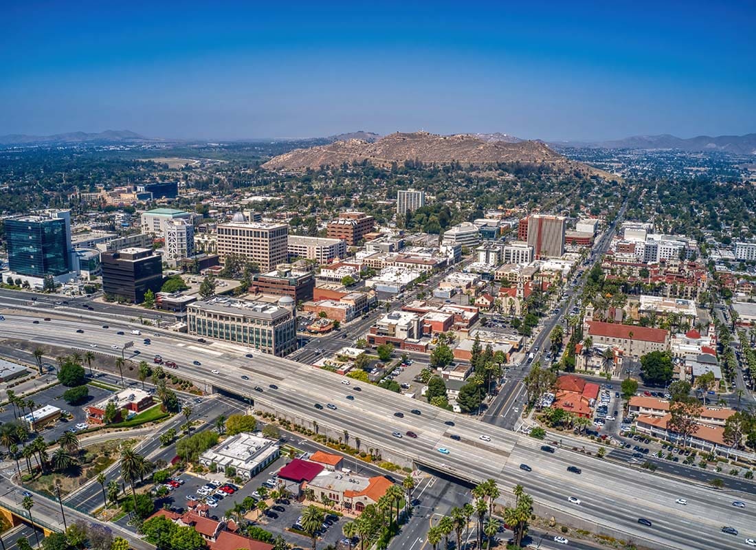 Riverside, CA - Aerial View of a Busy Highway in Downtown Riverside California with Surrounding Buildings on a Sunny Day